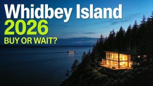 Modern home illuminated at twilight on a Pacific Northwest coastal bluff, representing the choice between renting and buying on Whidbey Island.